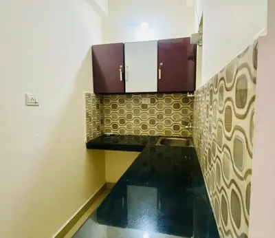 a bathroom with brown and black tiles on the wall at Flat in Guruvayur- Sooryamadhavam Apartments- Family only in Guruvāyūr