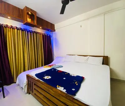 a bedroom with a large white bed and a window at Flat in Guruvayur- Sooryamadhavam Apartments- Family only in Guruvāyūr