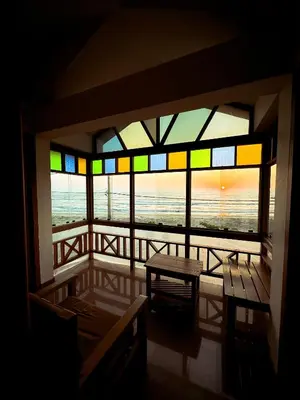 a room with a window with a view of the ocean at SeaCret by Dormer Stay in Kozhikode