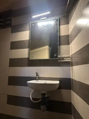 a bathroom with a sink and a mirror at SeaCret by Dormer Stay in Kozhikode