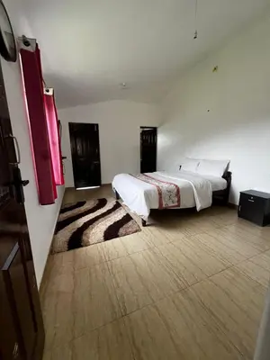 a bedroom with a large bed in a room at Hideaway Home43 in Ooty