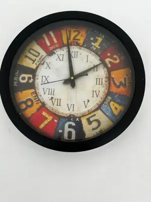 a clock is hanging on a wall at Hideaway Home43 in Ooty