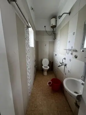 a bathroom with a toilet and a sink at Hideaway Home43 in Ooty