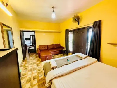 a living room with two beds and a couch at Teyt Castle - Ooty - Nilgiris in Ooty