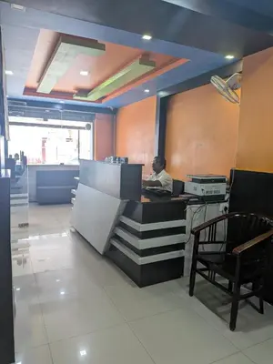 a person sitting at a desk in a office at Hotel TriColors Ramnagar Gandhipuram in Coimbatore