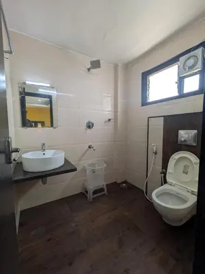 a bathroom with a toilet and a sink at Hotel TriColors Ramnagar Gandhipuram in Coimbatore