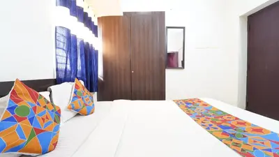 a bedroom with a large bed with colorful pillows at Airport Home Stay in Coimbatore