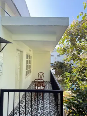 a chair sitting on a balcony of a building at Paradise Premium Villa Munnar in Munnar