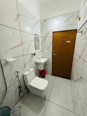 a bathroom with a toilet and a sink at Paradise Premium Villa Munnar in Munnar