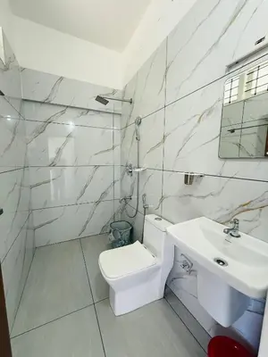 a white bathroom with a sink and a toilet at Paradise Premium Villa Munnar in Munnar