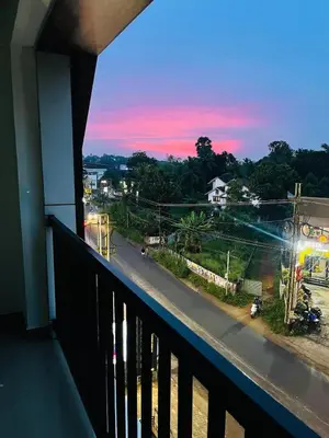 a balcony of a building with a view of a street at Crest By Irishighes in Perintalmanna