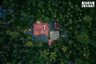 an aerial view of a house in the middle of a forest at StayVista at The River Mist with complimentary Breakfast & Bonfire in Wayanad