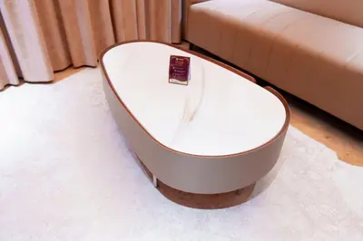 a white coffee table sitting next to a couch at celestia by thoppil in Kottakkal