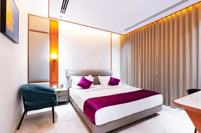 a bedroom with a bed and a desk and a chair at celestia by thoppil in Kottakkal