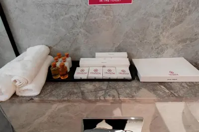 a tray with a pile of towels and bottles of alcohol at celestia by thoppil in Kottakkal