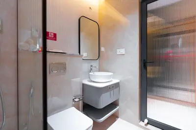 a bathroom with a sink and a toilet and a mirror at celestia by thoppil in Kottakkal