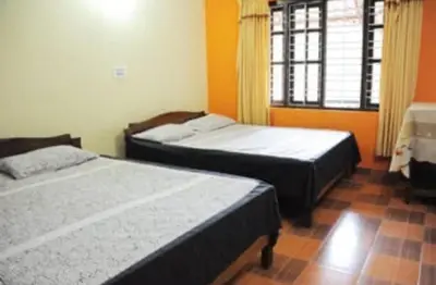 a bedroom with two beds and a window at Cozy Coffee Estate Homestay Coorg Madikeri in Madikeri