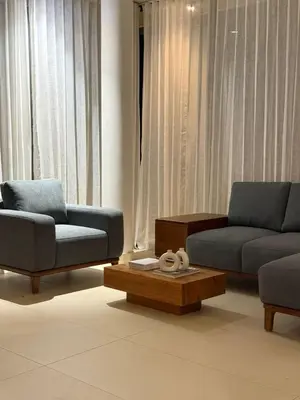a living room with two couches and a coffee table at Ozone The Misty Villa - Hill View in Coonoor