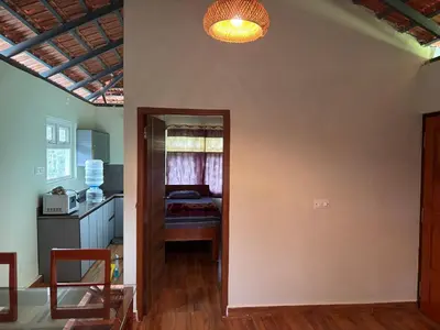a room with a door leading to a bedroom at Estate stay near Dubare elephant camp, friendly for remote workers in Siddapur