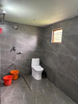 a bathroom with a toilet and a window at Estate stay near Dubare elephant camp, friendly for remote workers in Siddapur