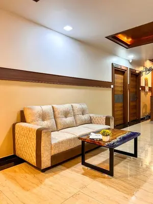 a living room with a couch and a table at Shri Amman Residency in Dhārāpuram
