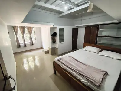 a bedroom with a large bed in a room at Resonanace Homestay Nature Stay in Wayanad in Pulpally
