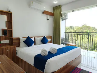 a bedroom with a large bed with towels on it at Nirvanica Retreat Wayanad in Padinjarathara