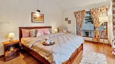 a bedroom with a large bed and a window at SaffronStays Chamomile Hills in Kotagiri