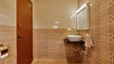 a bathroom with a sink and a mirror at SaffronStays Chamomile Hills in Kotagiri