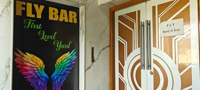 a door with a sign that says fly bar first loved yard at RR Grand Inn in Coimbatore
