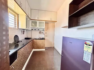a kitchen with a purple refrigerator in a room at Rohi stays 2 bed room flats in Mysore