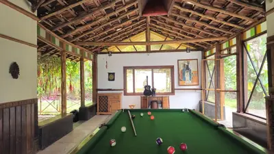 a room with a pool table in a house at Grace Backwater Villa Coorg in Suntikoppa