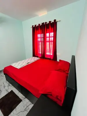 a red bed in a room with a red window at Edakkal Hearth in Ambalavayal