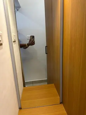 a person holding a camera taking a picture of a door at Rivera resort and wellness center in Kodanad