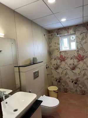 a bathroom with a toilet and a sink at Rivera resort and wellness center in Kodanad