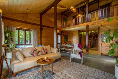 a living room with a couch and a table at amã Stays & Trails - Iris Villa, Kozhikode in Puthuppādi