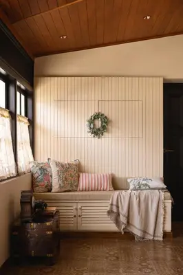 a room with a bench with pillows on it at amã Stays & Trails - Mount Pleasant, Coonoor in Coonoor