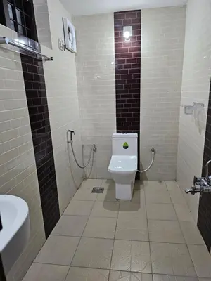 a bathroom with a toilet and a sink at Mount Wave Holiday Pool Villa in Wayanad