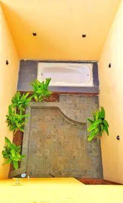 a bath tub in a room with plants at Eden Garden Bandipur Tiger Reserve in Gundlupet