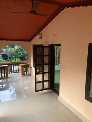 an open door to a room with a patio at nandanam villlas in Guruvāyūr