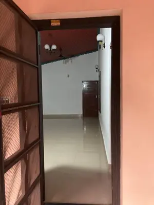 an open door to a hallway with a mirror at nandanam villlas in Guruvāyūr