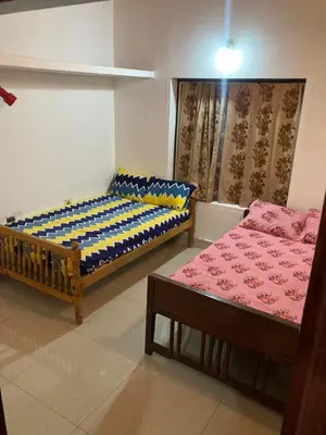 a room with two beds and a couch at nandanam villlas in Guruvāyūr