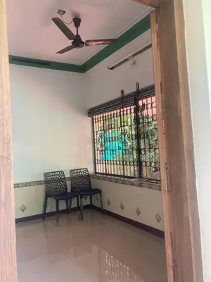 a room with two chairs and a ceiling fan at nandanam villlas in Guruvāyūr