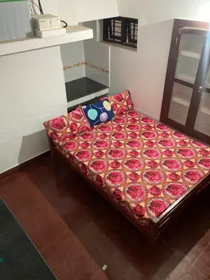 a bed sitting in a room with at nandanam villlas in Guruvāyūr