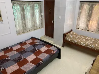 a bedroom with a bed and a couch in it at nandanam villlas in Guruvāyūr