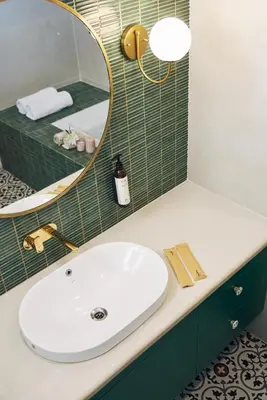 a bathroom with a white sink and a mirror at Okka by Raho - A colonial style villa in Coorg in Siddapur