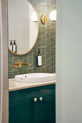 a bathroom with a sink and a mirror at Okka by Raho - A colonial style villa in Coorg in Siddapur
