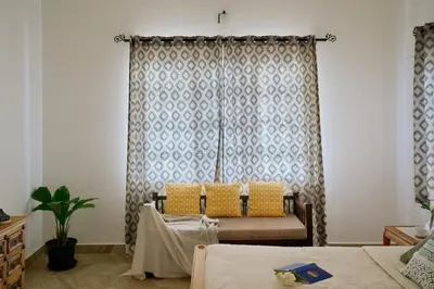 a living room with a couch and a table at Okka by Raho - A colonial style villa in Coorg in Siddapur