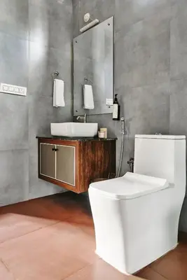 a bathroom with a white toilet and a sink at Nila by Raho - Secluded Villa with Estate View in Siddapur