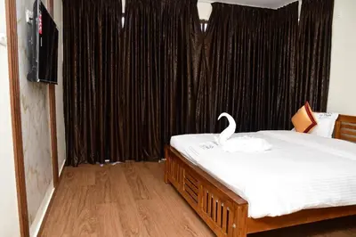 a bedroom with a bed with a swan on it at LaFiesta in Kodaikānāl